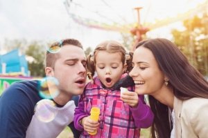 Family with child in amusement park