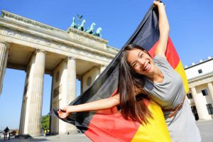 Female tourist holding German flag in Berlin