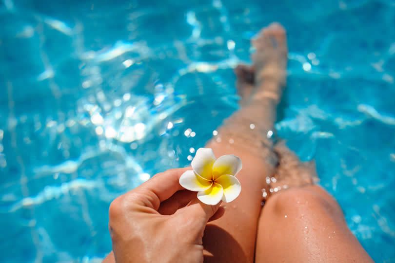 Woman with flower in pool